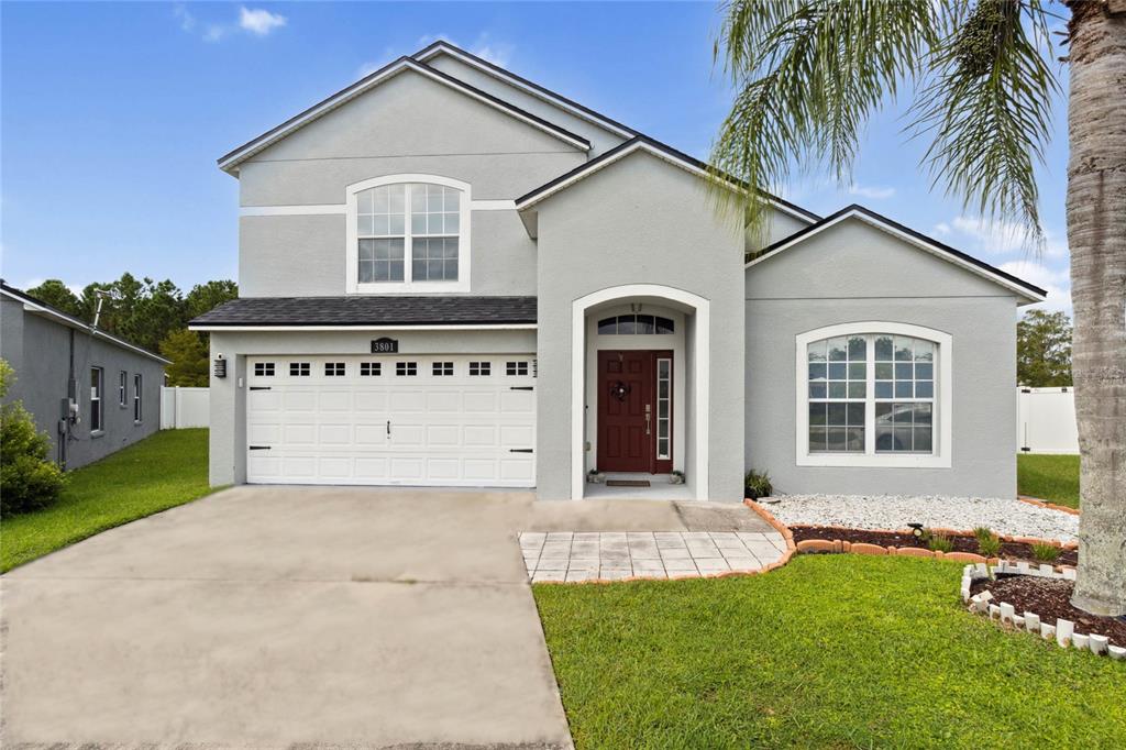 a front view of a house with a yard and garage