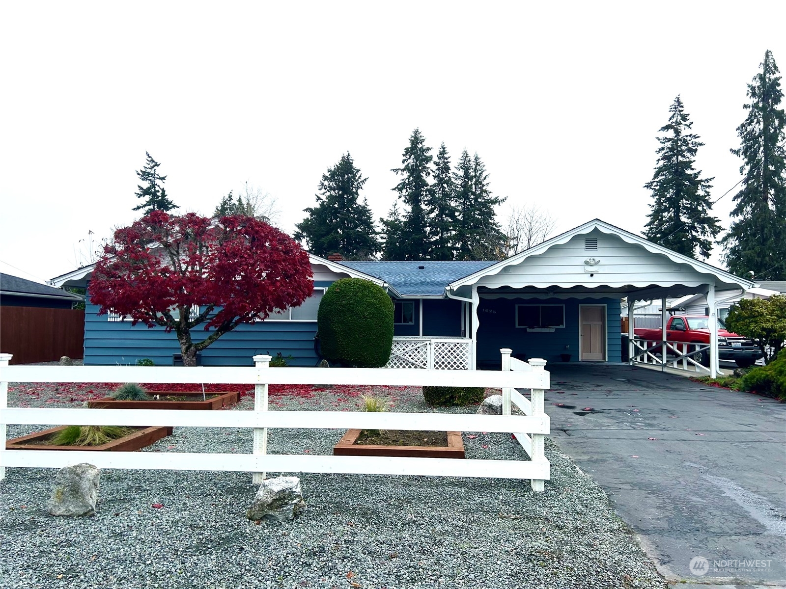 a view of house with outdoor space and parking