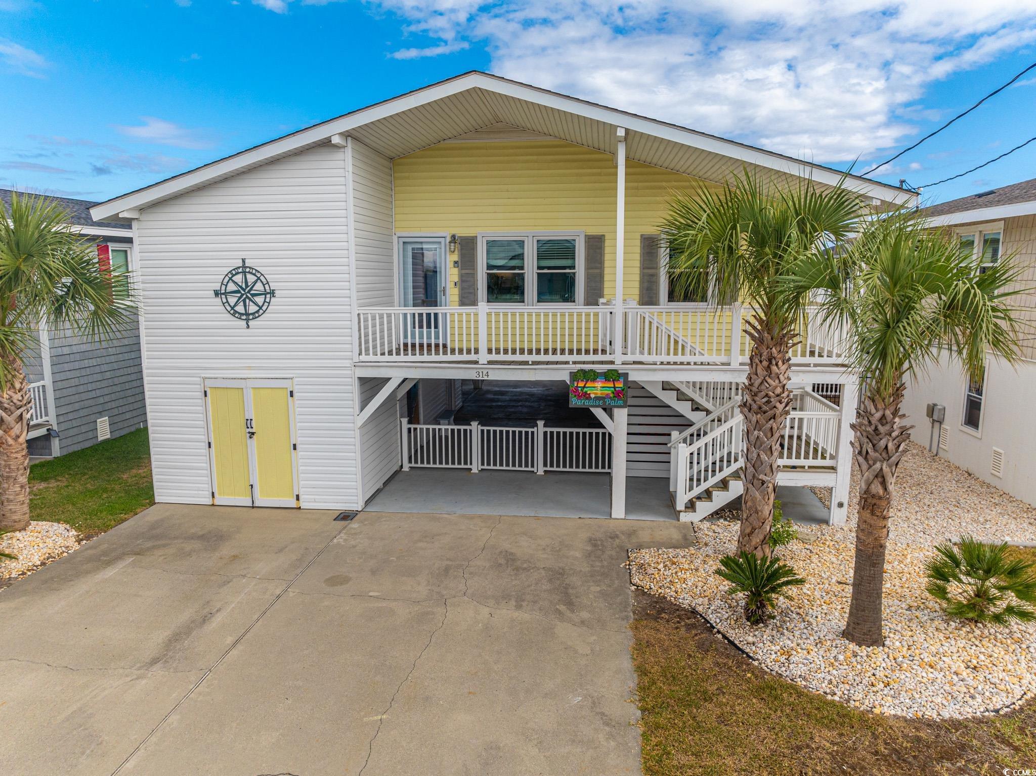 View of front of property with covered porch and a