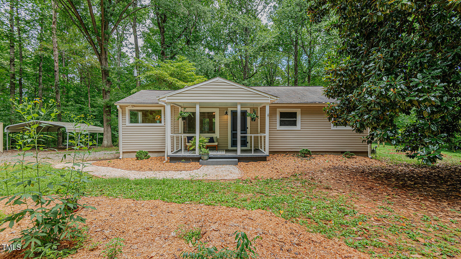 a front view of a house with yard patio and green space