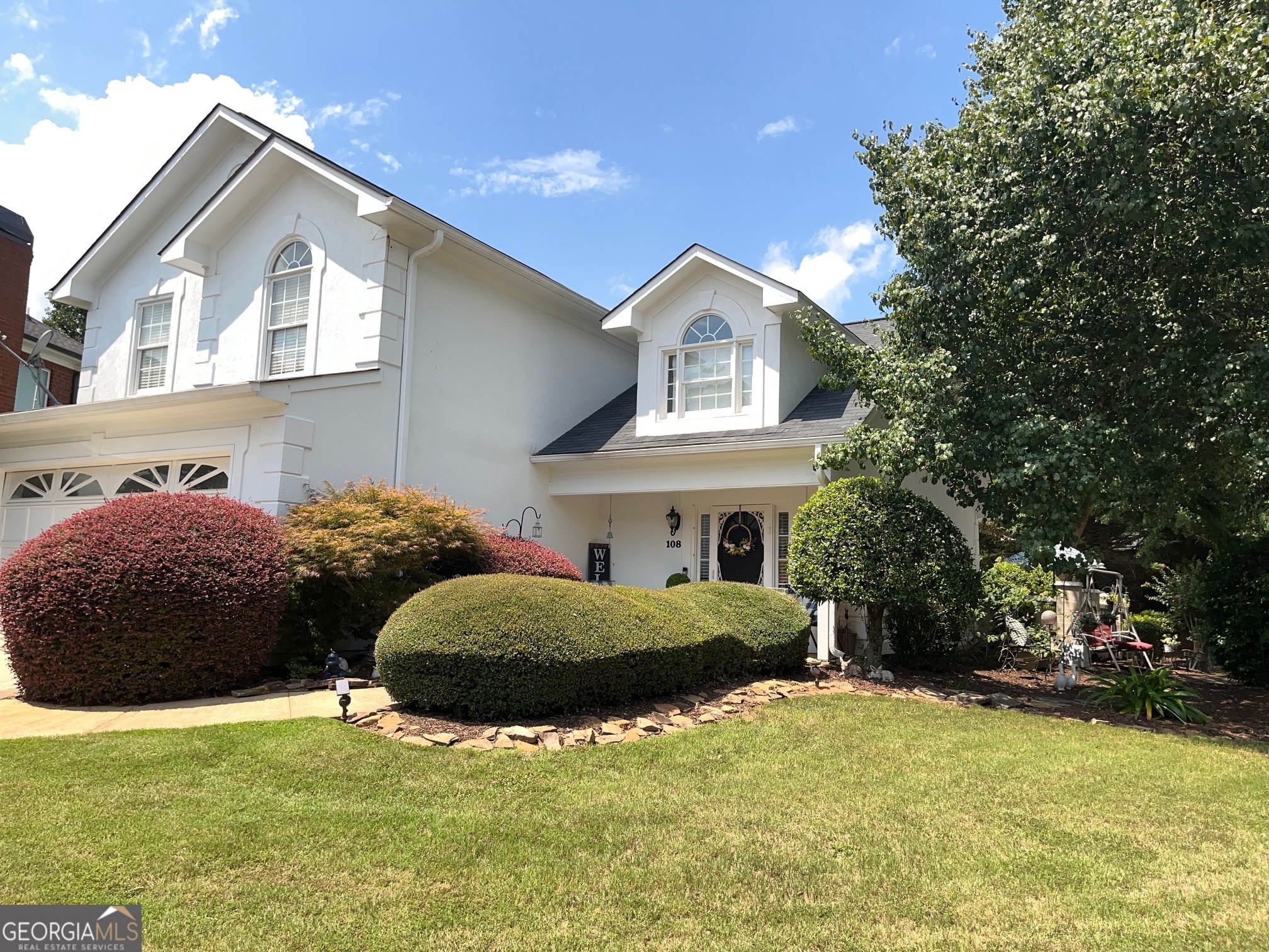 a front view of a house with garden