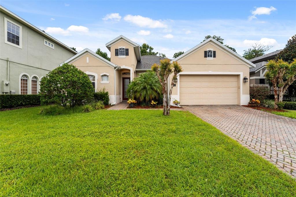 a front view of a house with a yard and garage