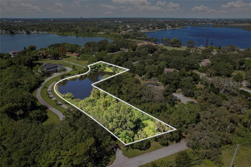 an aerial view of a house with a garden and lake view