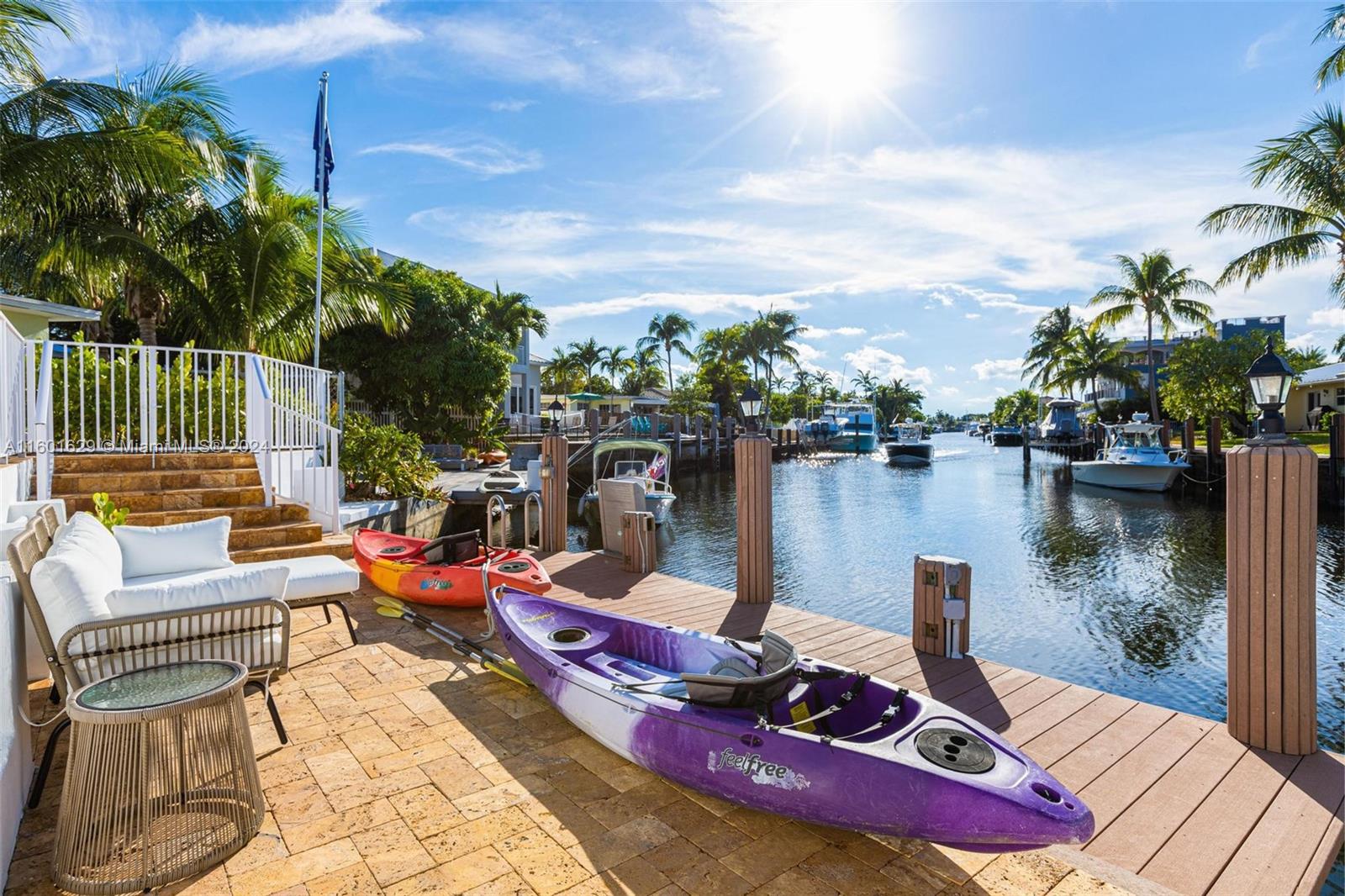 a view of a ocean from deck with furniture