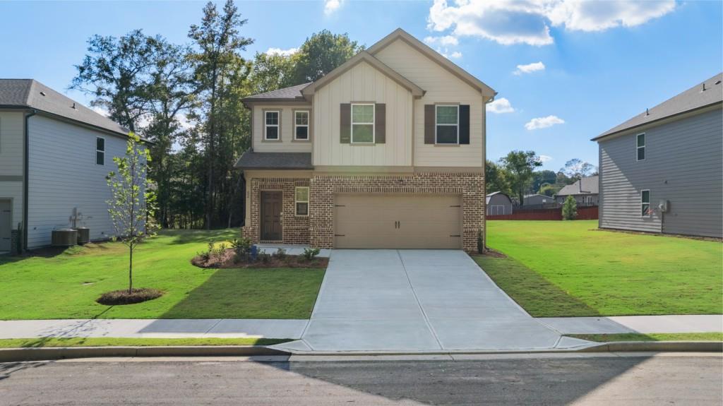 a front view of house with yard and green space