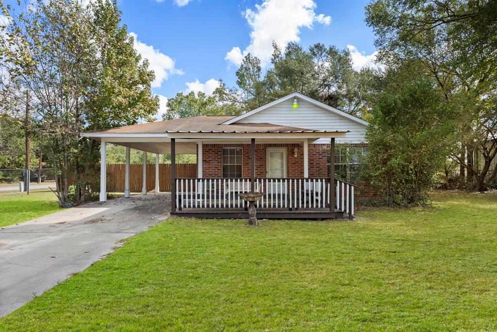 a view of a house with a deck and a yard