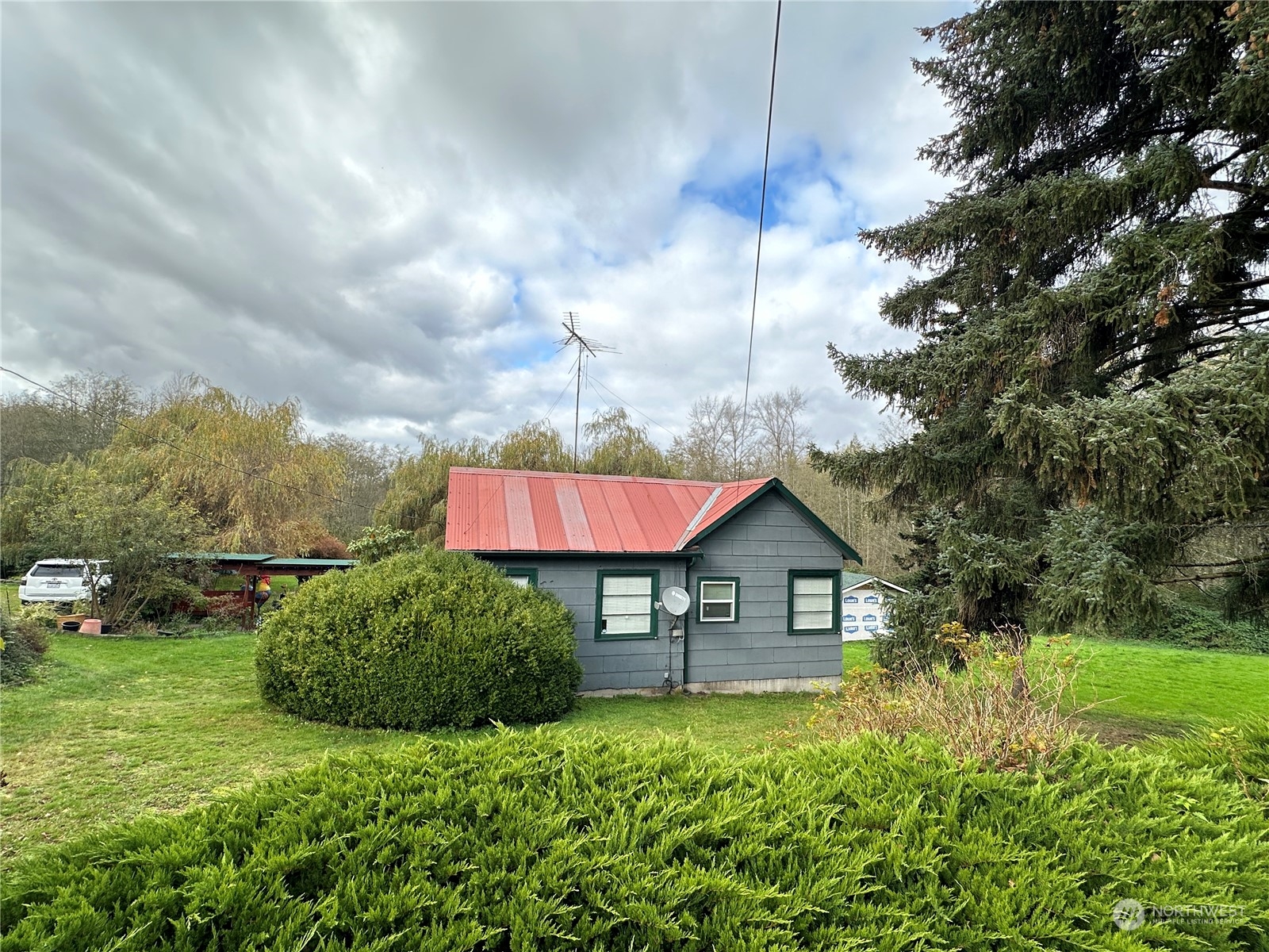 a view of a house with a yard and hanging chair