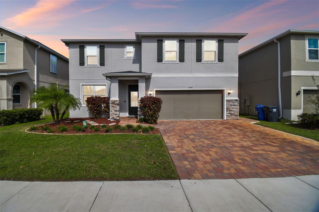 a front view of a house with a yard and garage