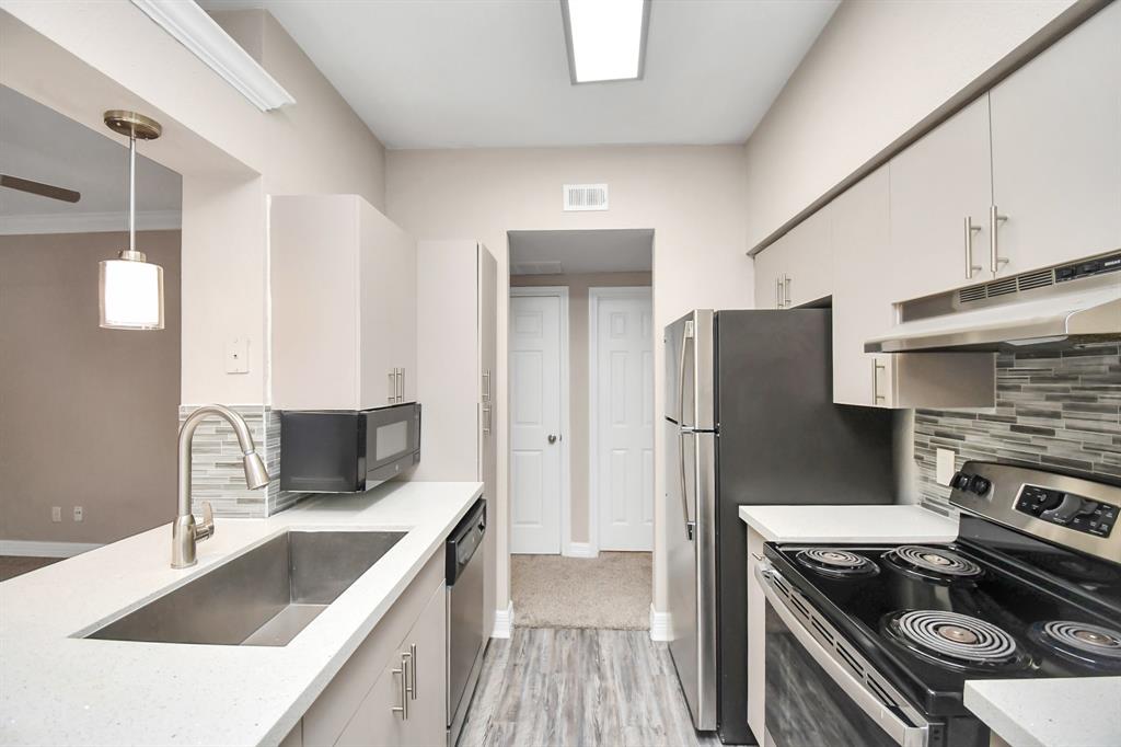 a kitchen that has a sink and a stove