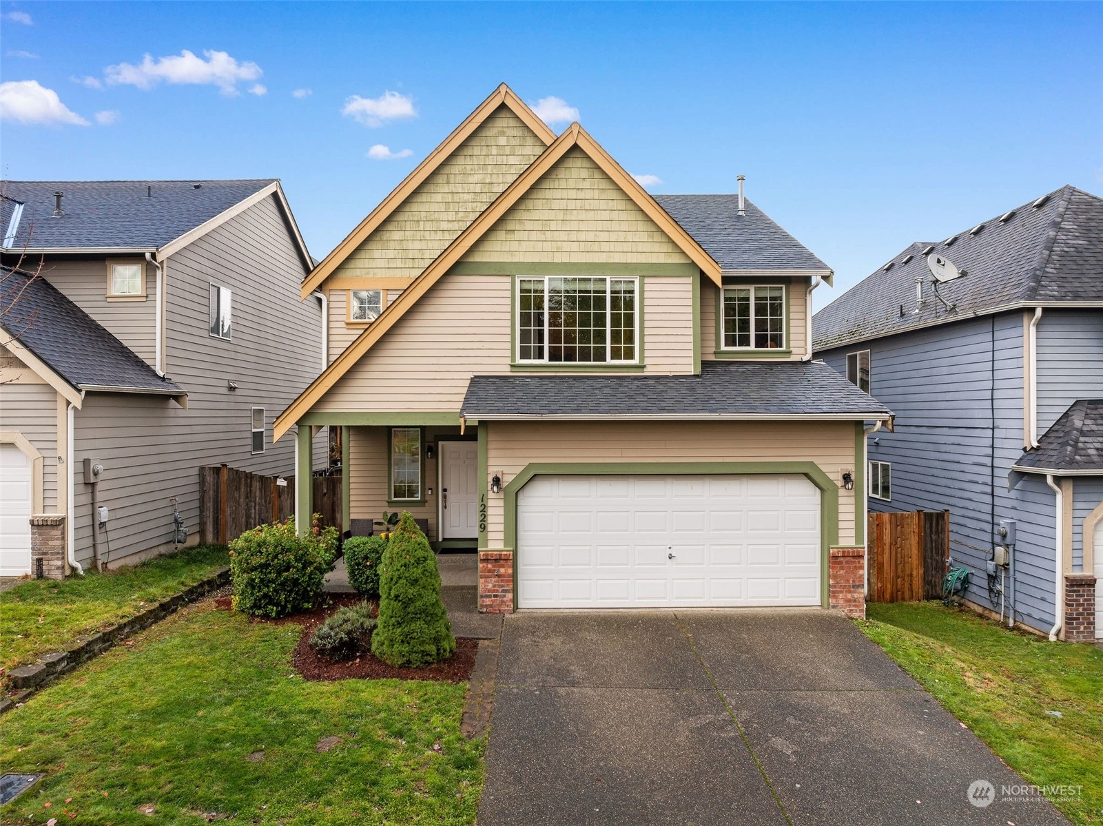 a front view of a house with a yard and garage