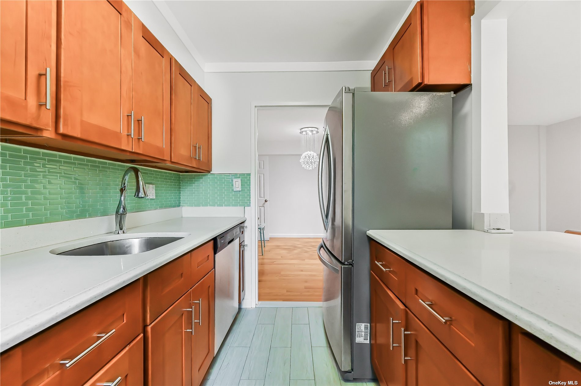 a kitchen with stainless steel appliances granite countertop a sink and a refrigerator