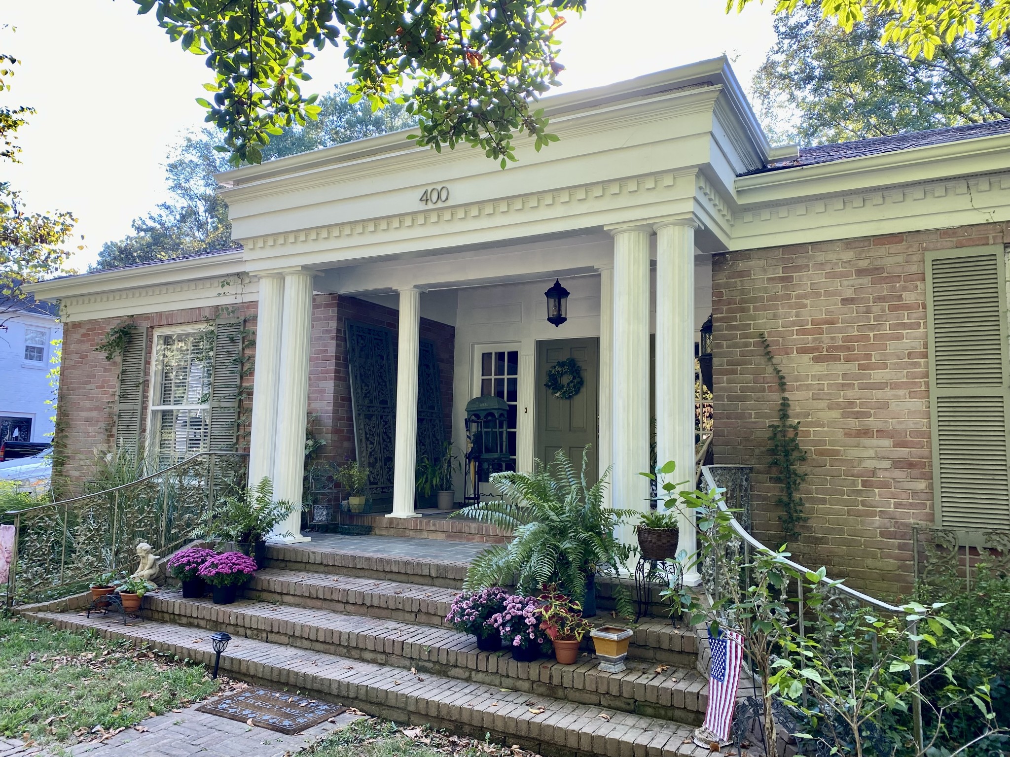 a view of a house with potted plants