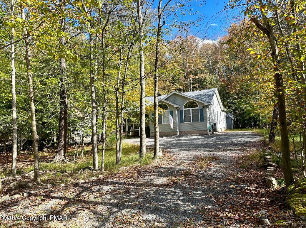 a view of house with a backyard