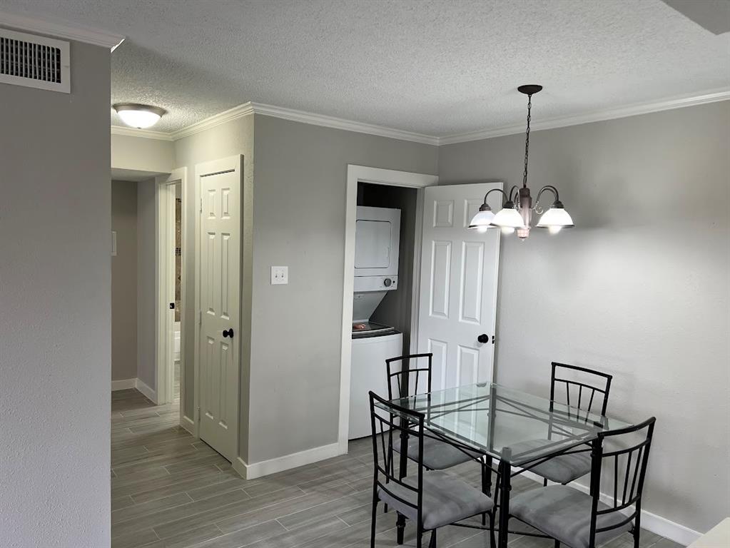 The dining area seamlessly combines with the convenience of an integrated washer and dryer.