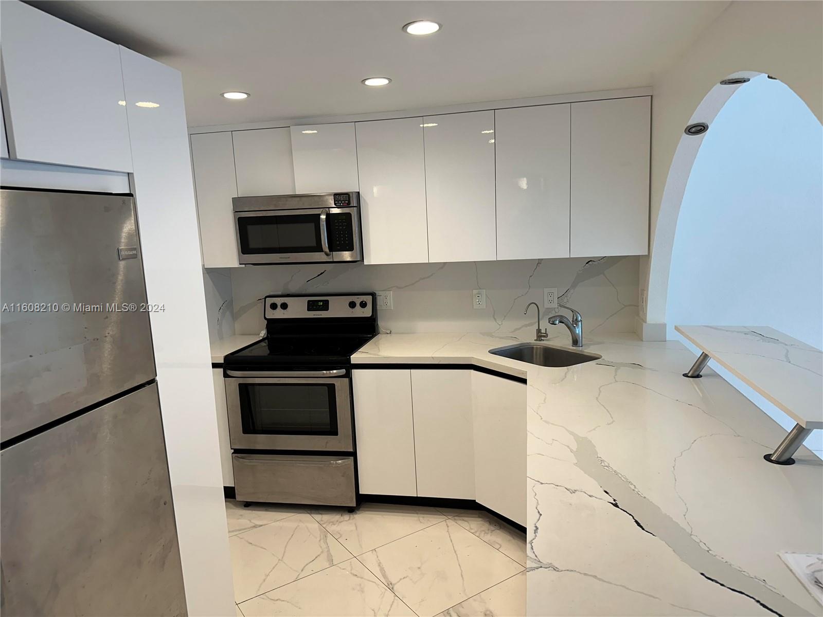 a kitchen with a sink and a stove top oven