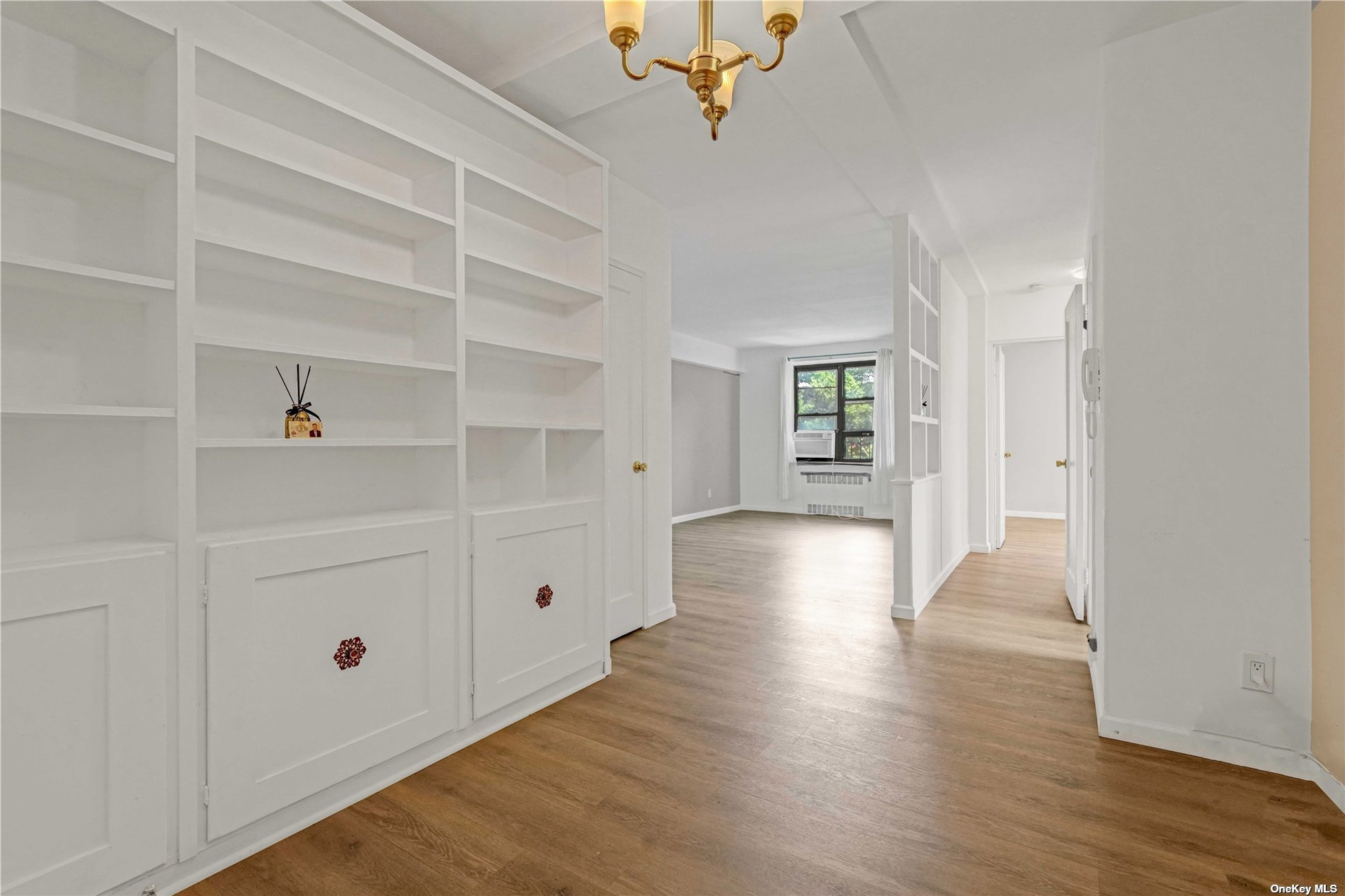 a view of an empty room with wooden floor