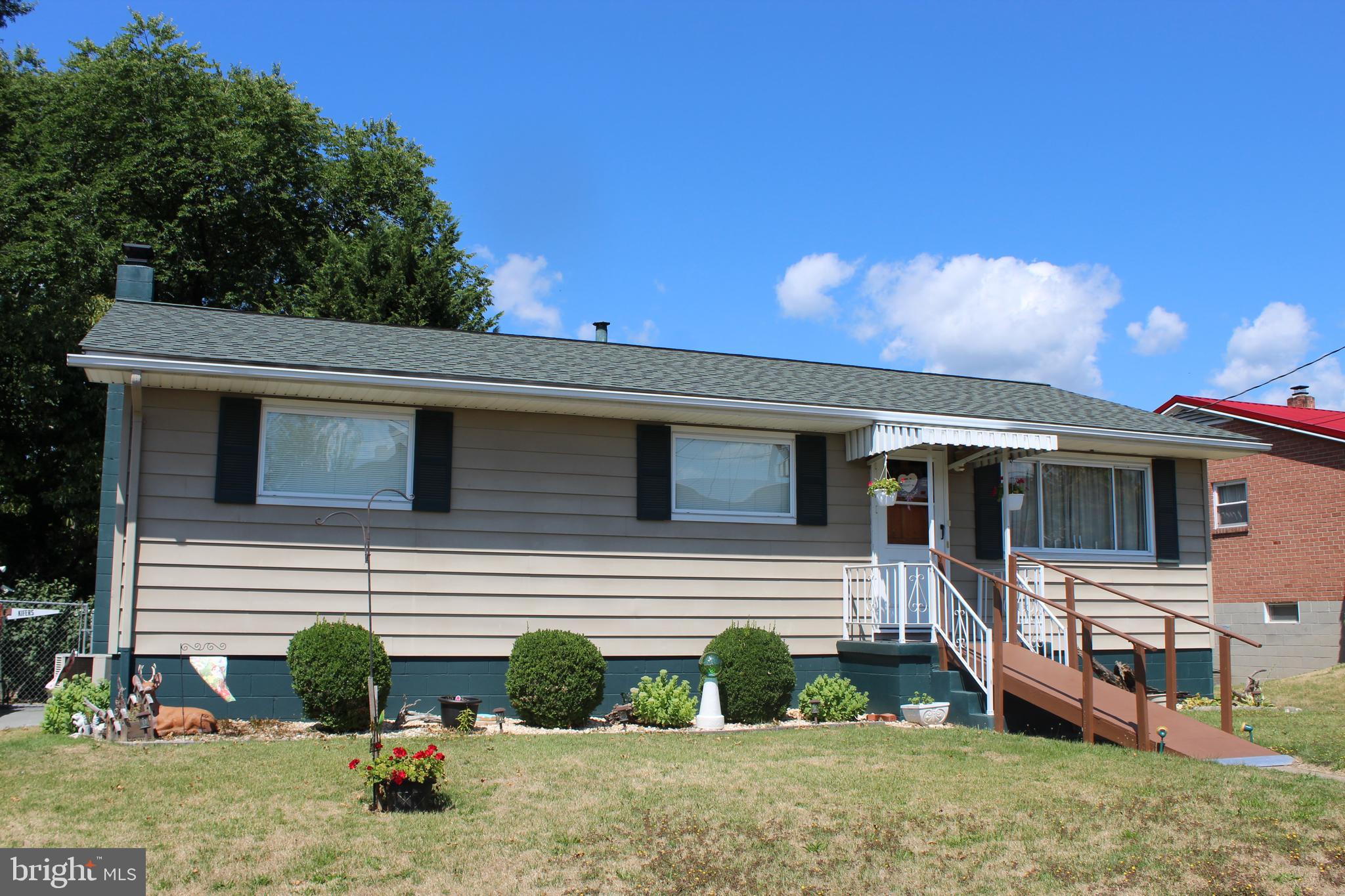 a front view of a house with garden