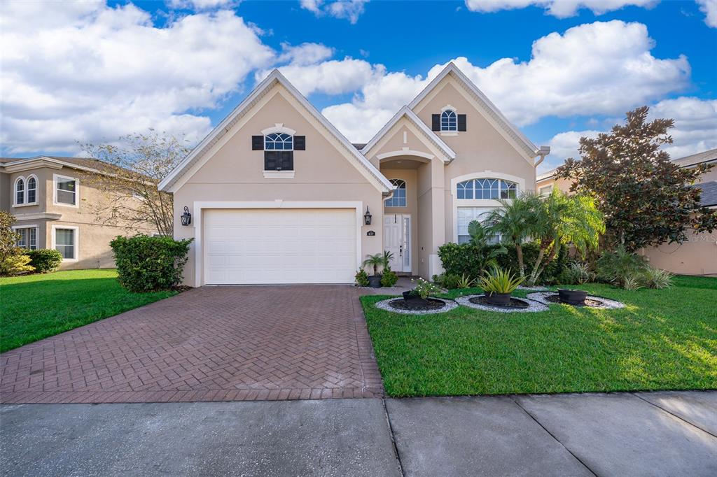 a front view of a house with a yard and garage