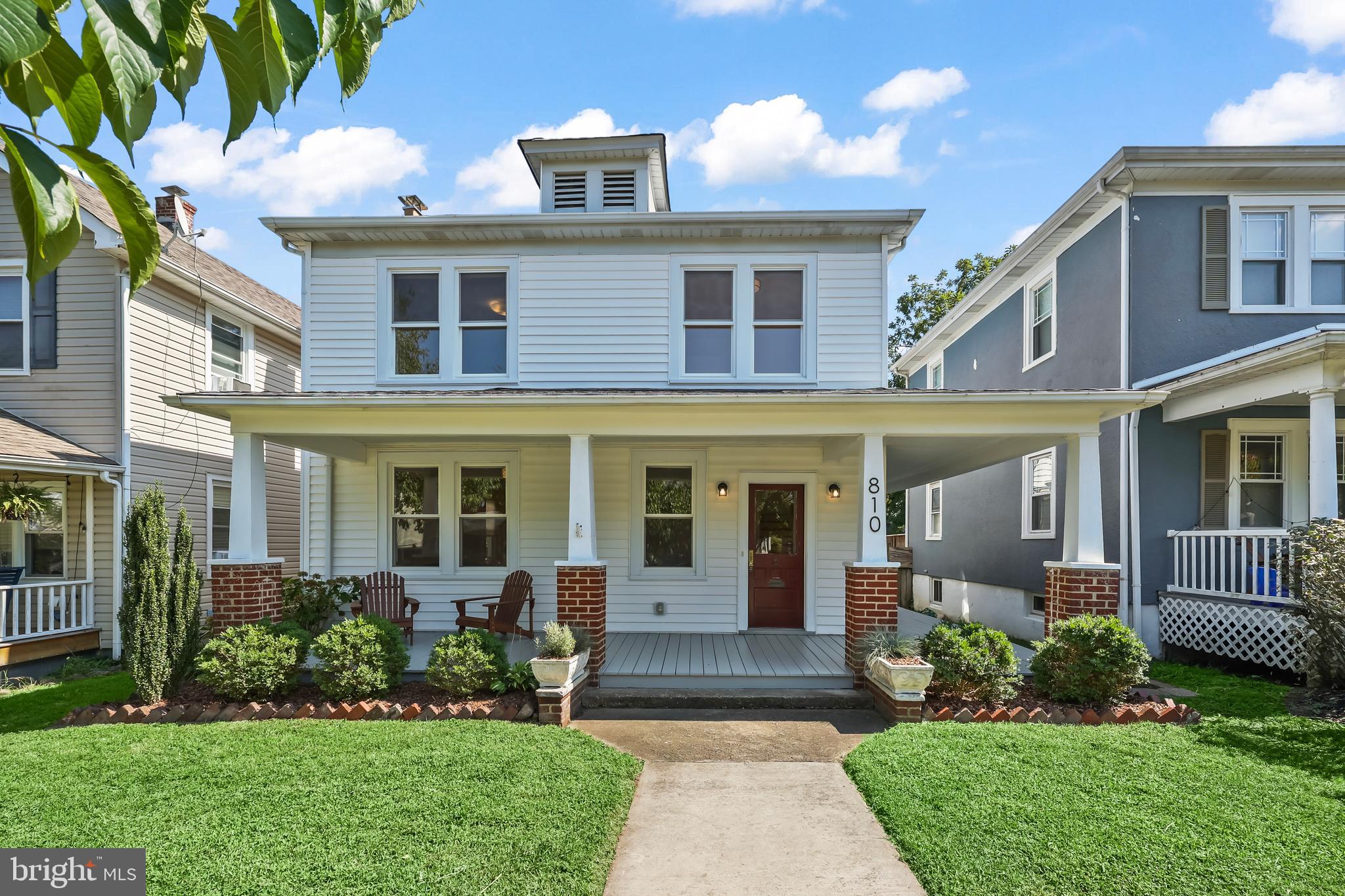 a front view of a house with garden and porch