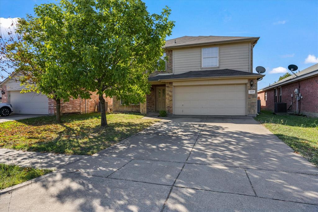 a front view of a house with a yard and a garage