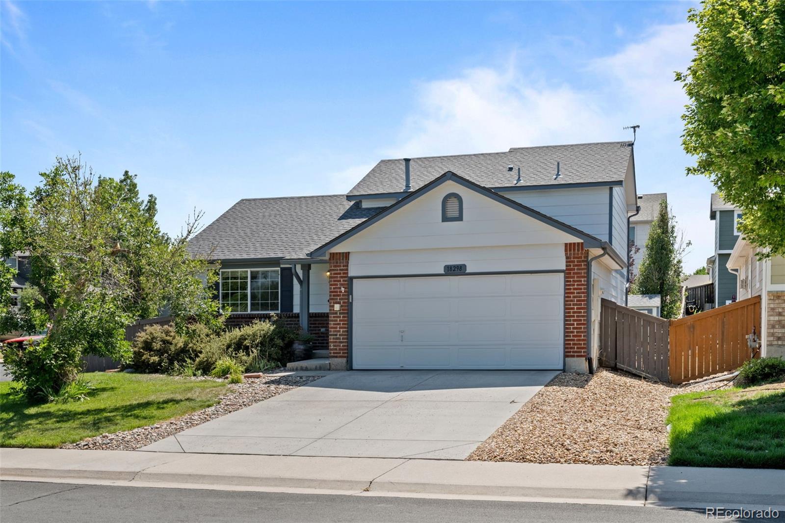 front view of house with a yard and car parked