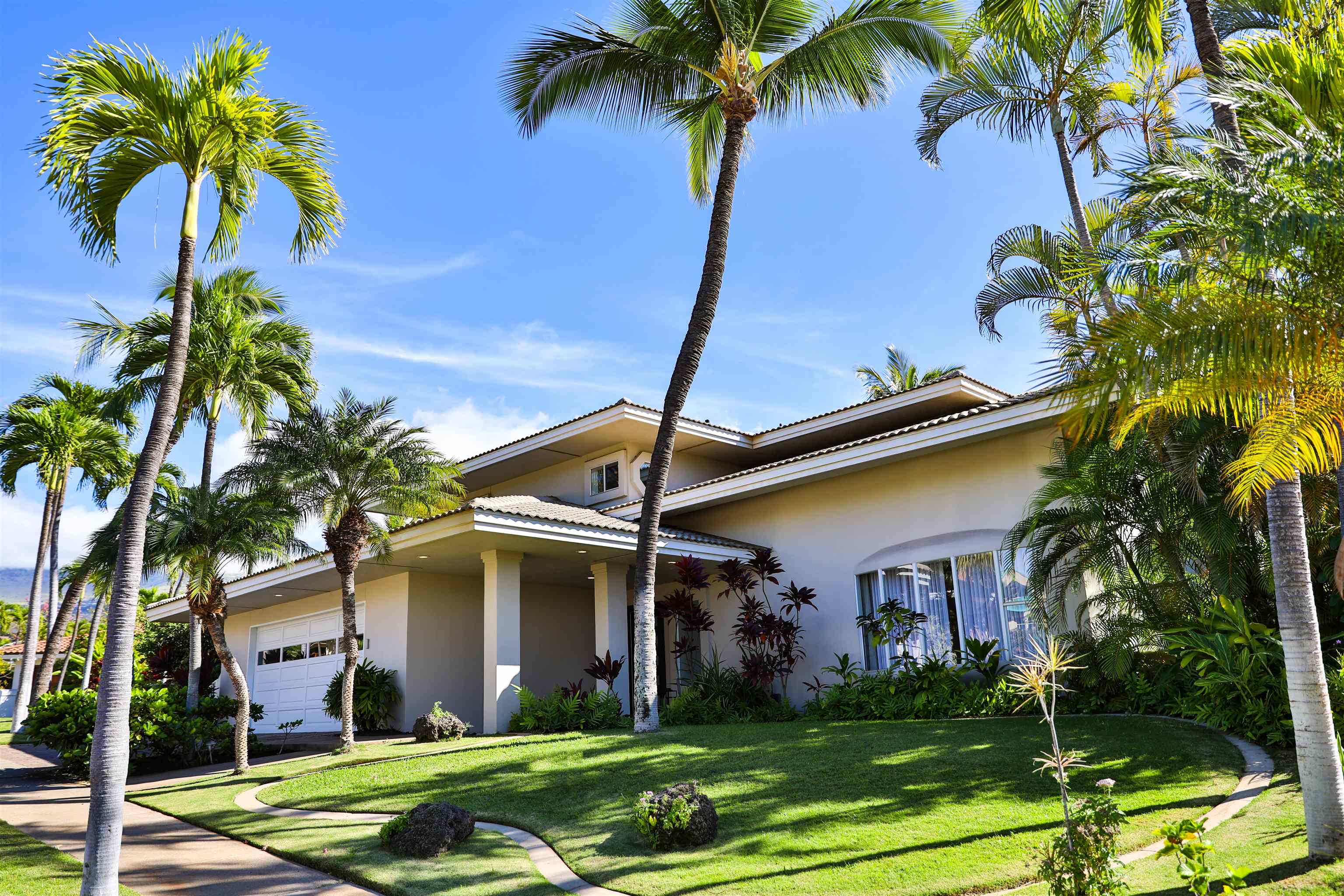 a front view of a house with garden