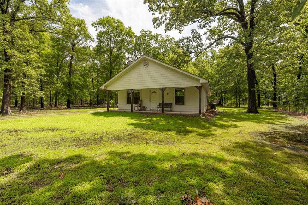 a front view of a house with yard and green space