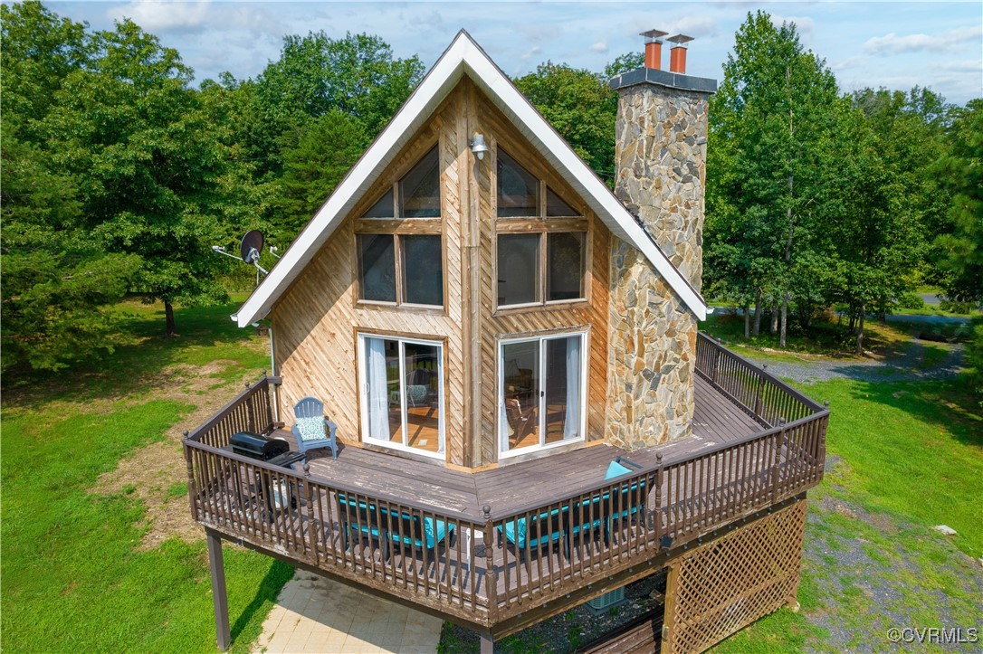 a view of a house with a small deck and a yard