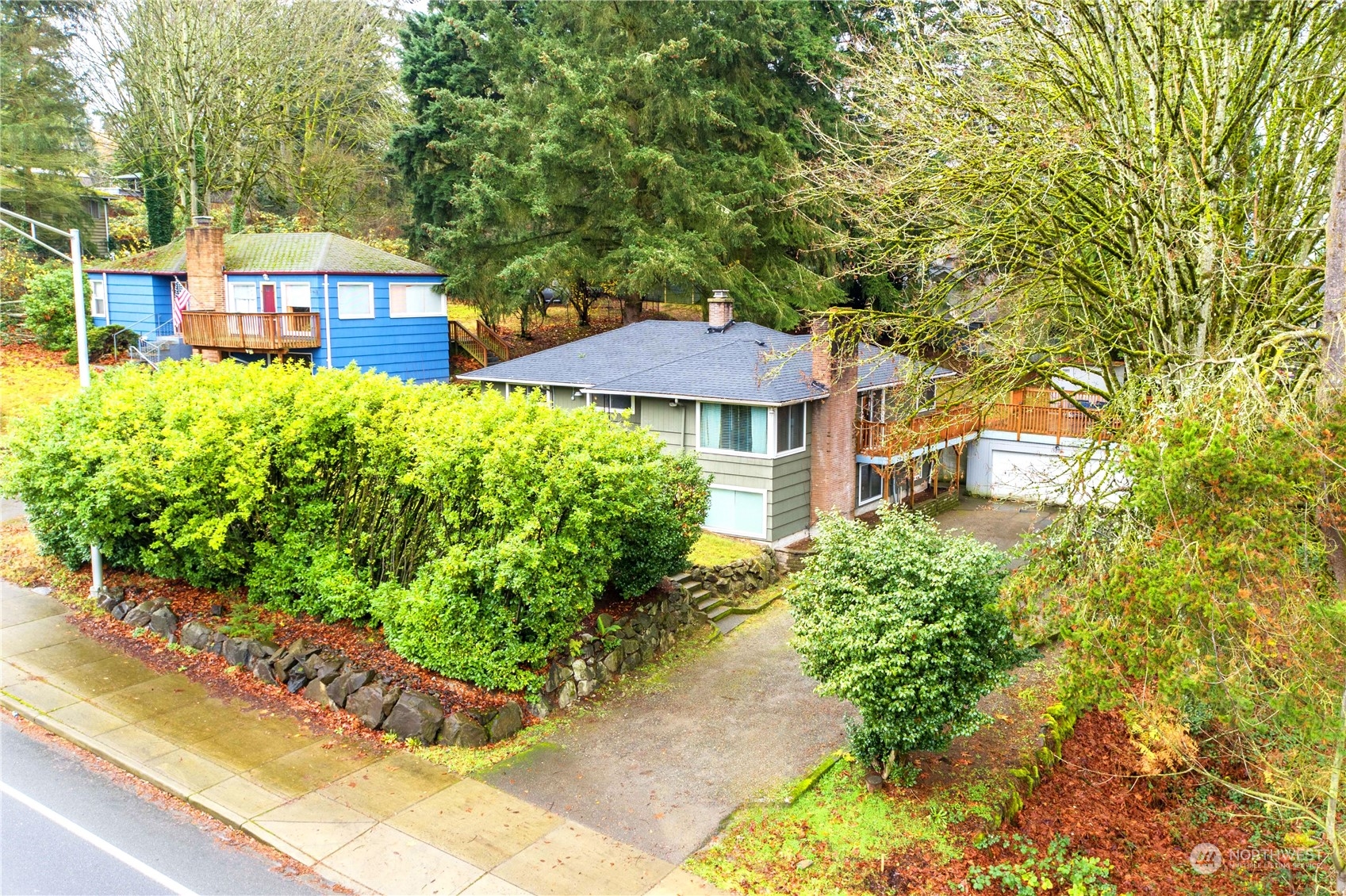 a front view of a residential houses with yard and green space