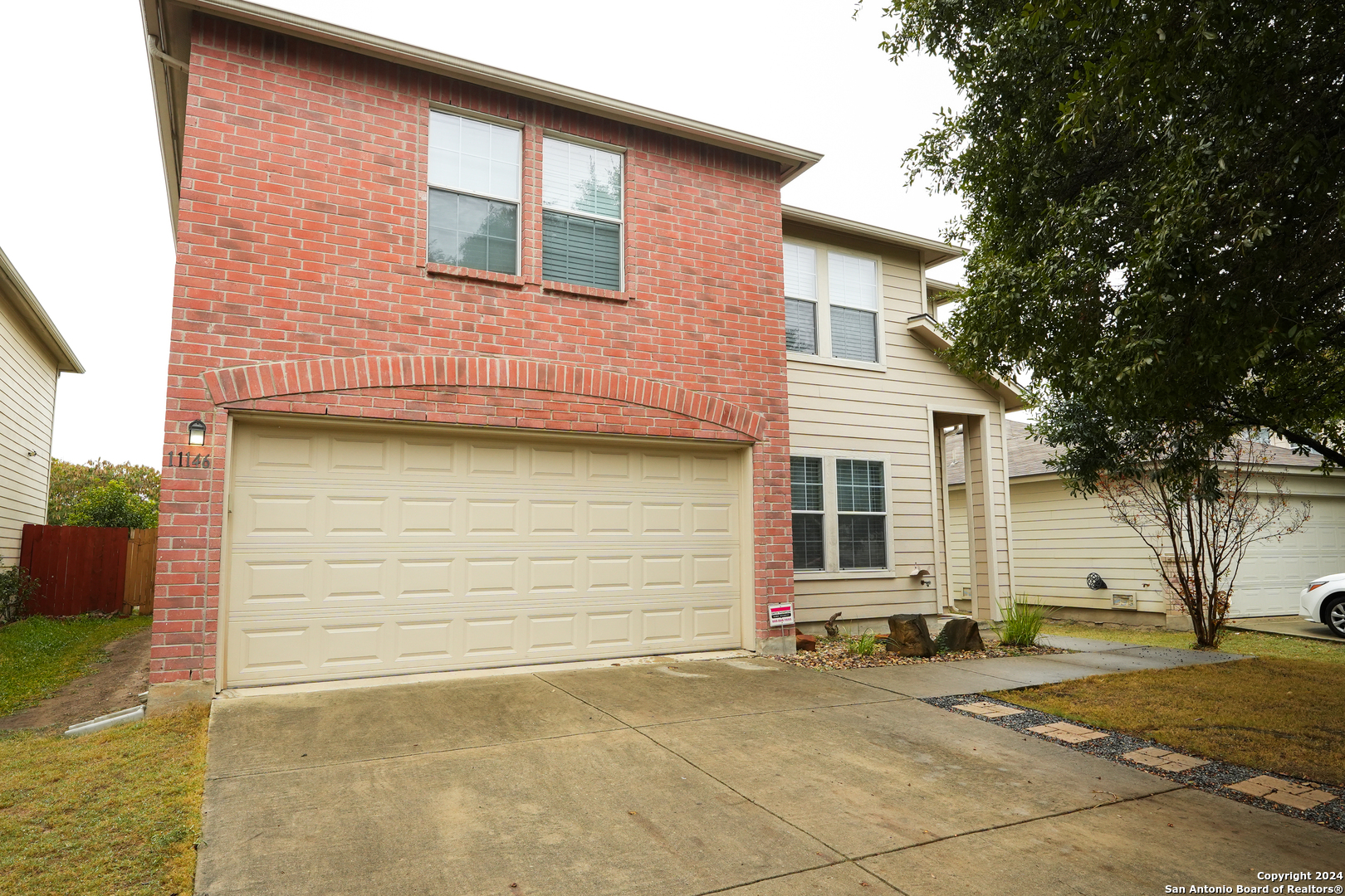 a view of a house with a yard and garage