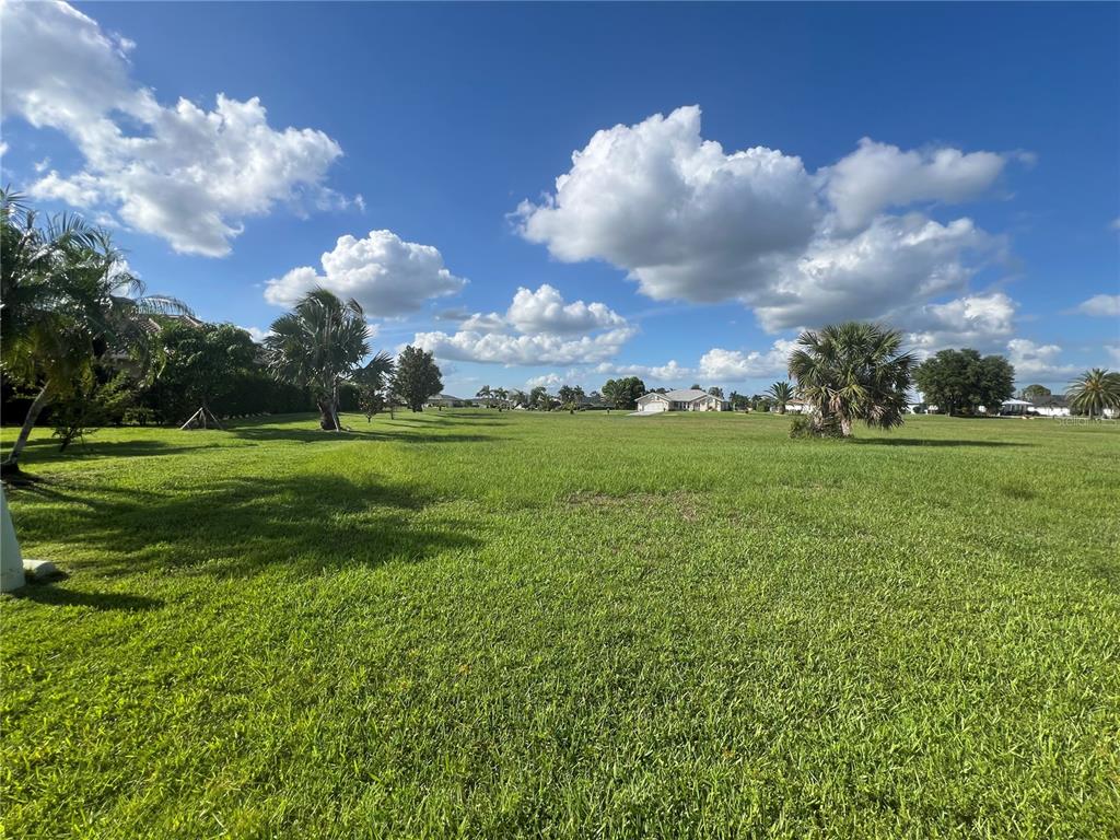 a view of a golf course with an trees