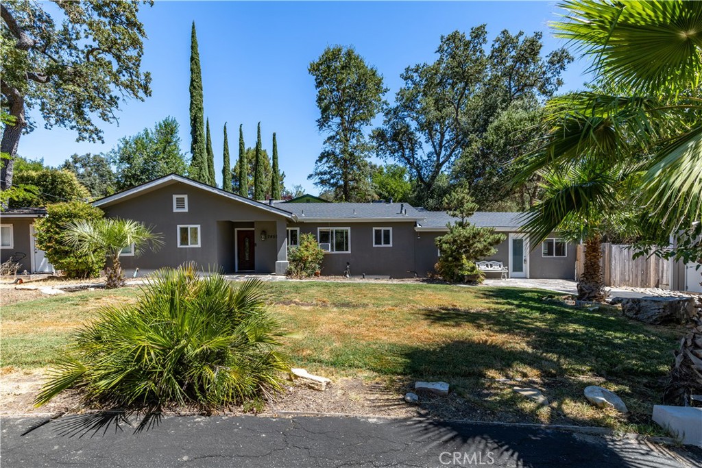 a front view of a house with a garden