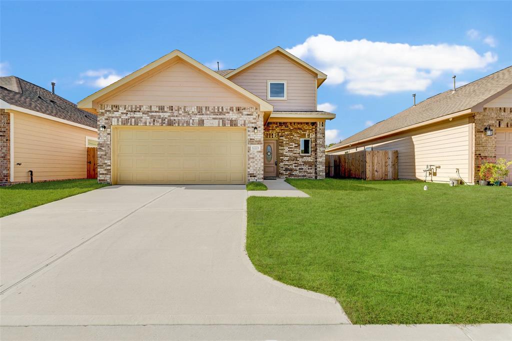 a front view of a house with yard and garage