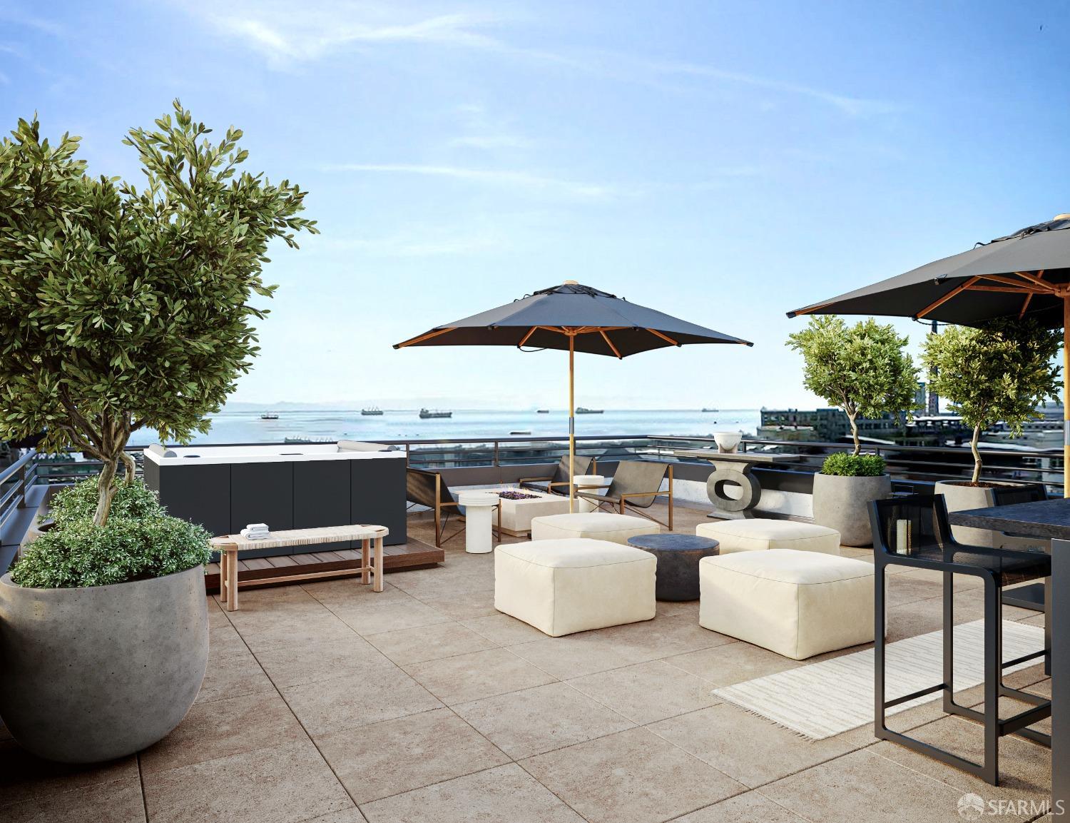 a view of a patio with couches table and chairs under an umbrella with a barbeque