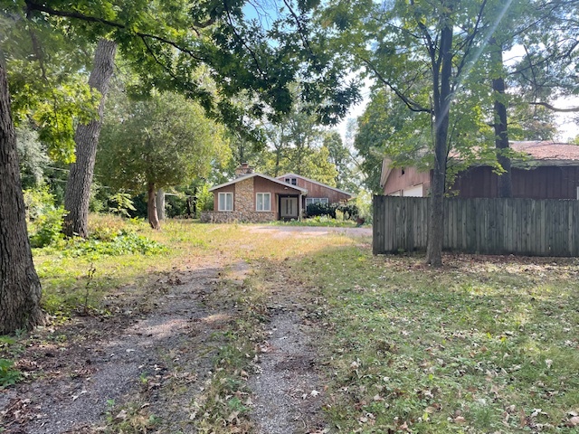 a view of a house with yard and sitting area