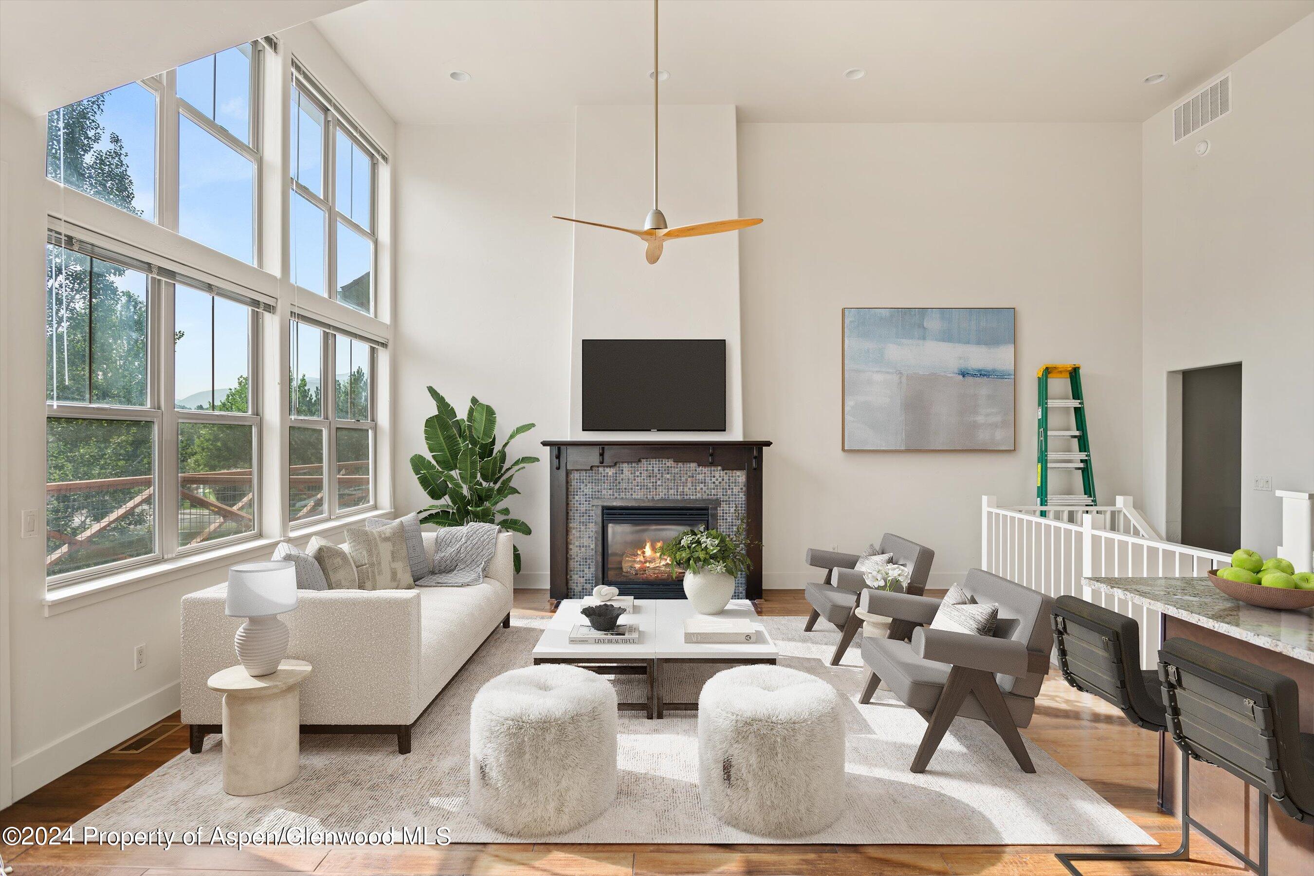 a living room with furniture a fireplace and a flat screen tv