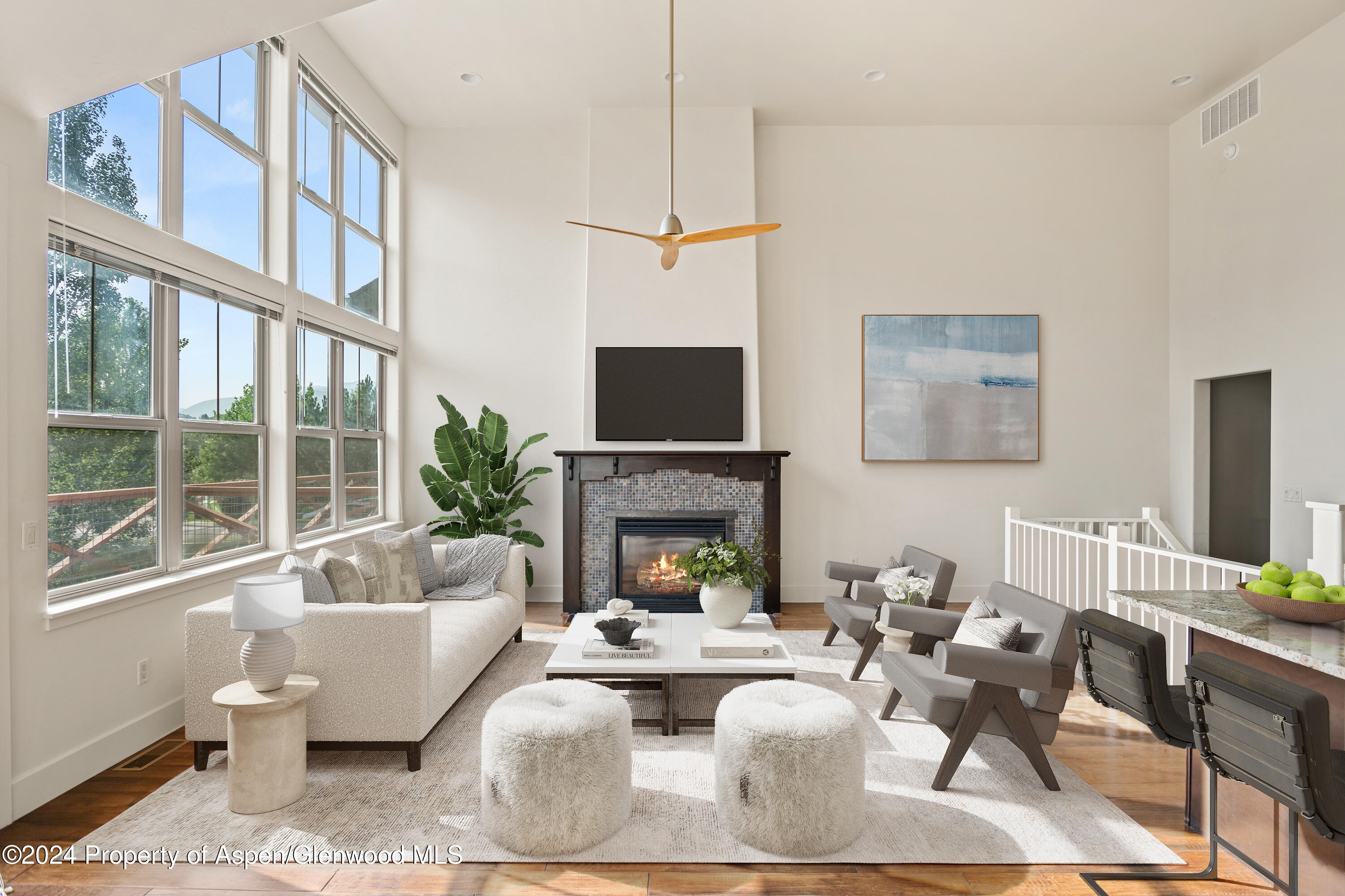 a living room with furniture a fireplace and a flat screen tv