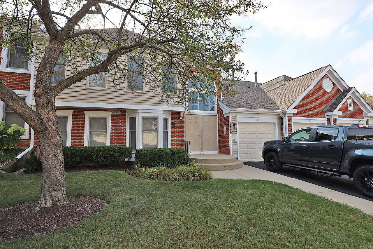 a car parked in front of a house and a yard