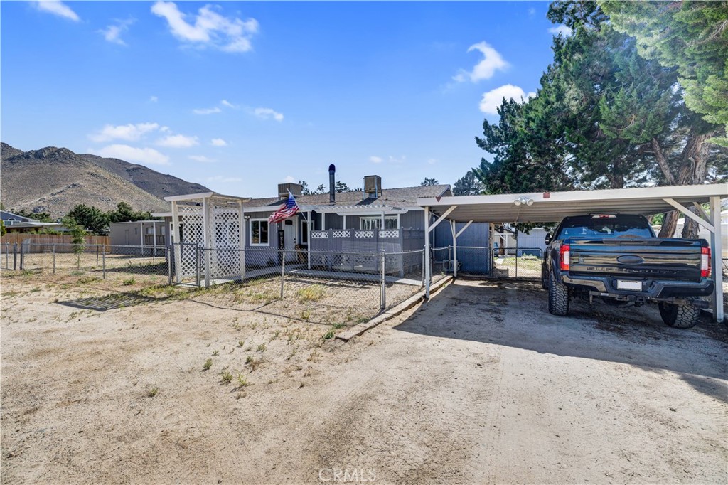 a view of a house with a yard and sitting area