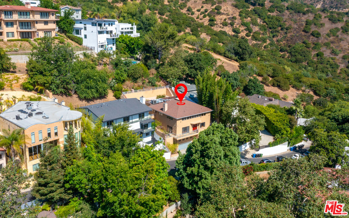 an aerial view of multiple houses with yard