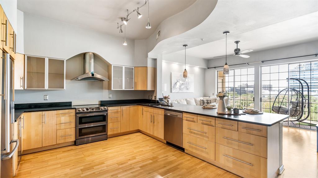 a kitchen with stainless steel appliances a sink stove and cabinets