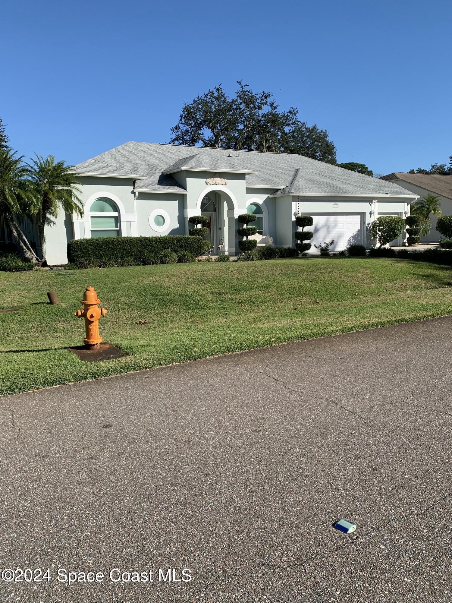 a front view of a house with a yard