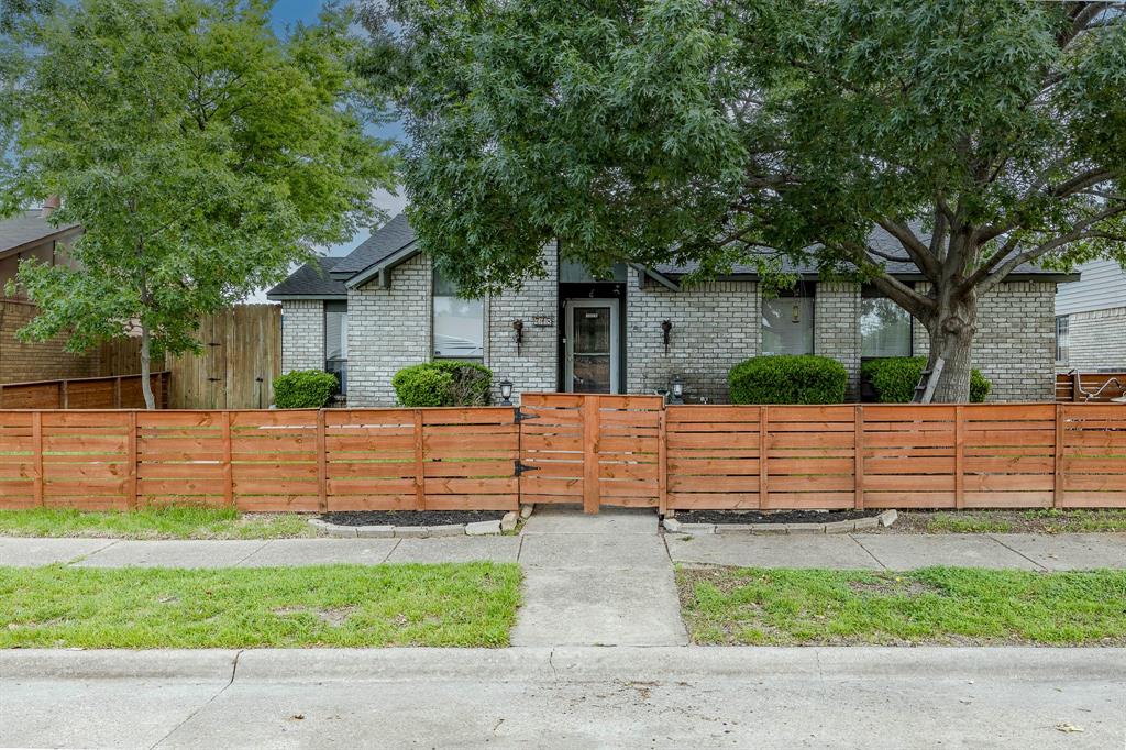 a front view of a house with a fence