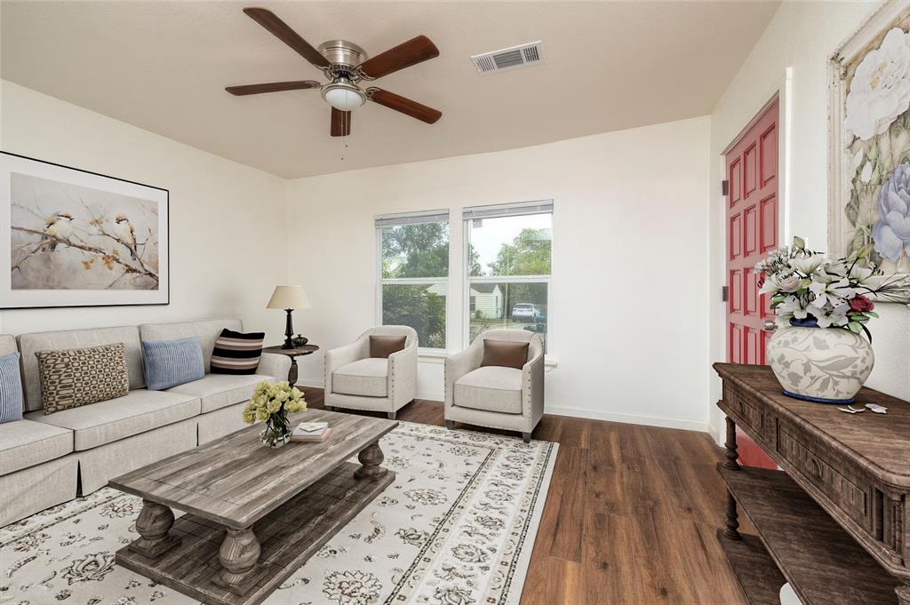 a living room with furniture and wooden floor