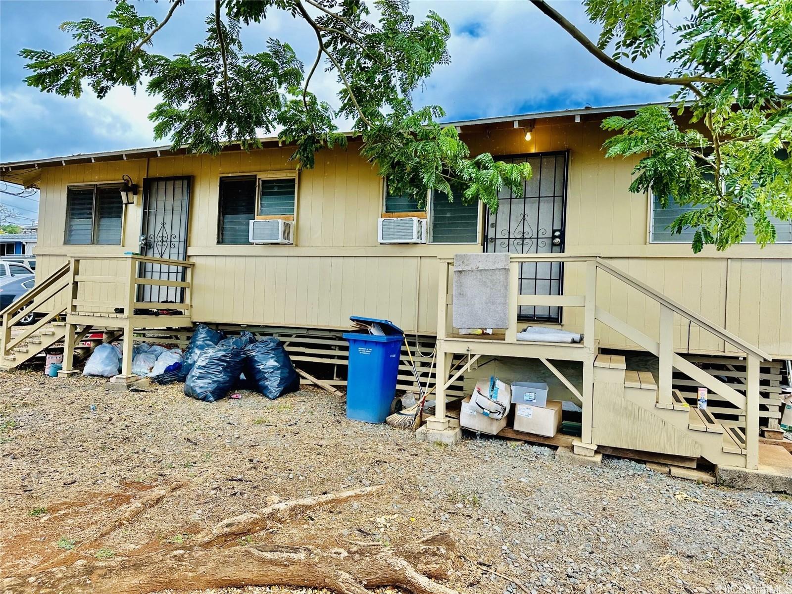 a view of a house with a yard and sitting area