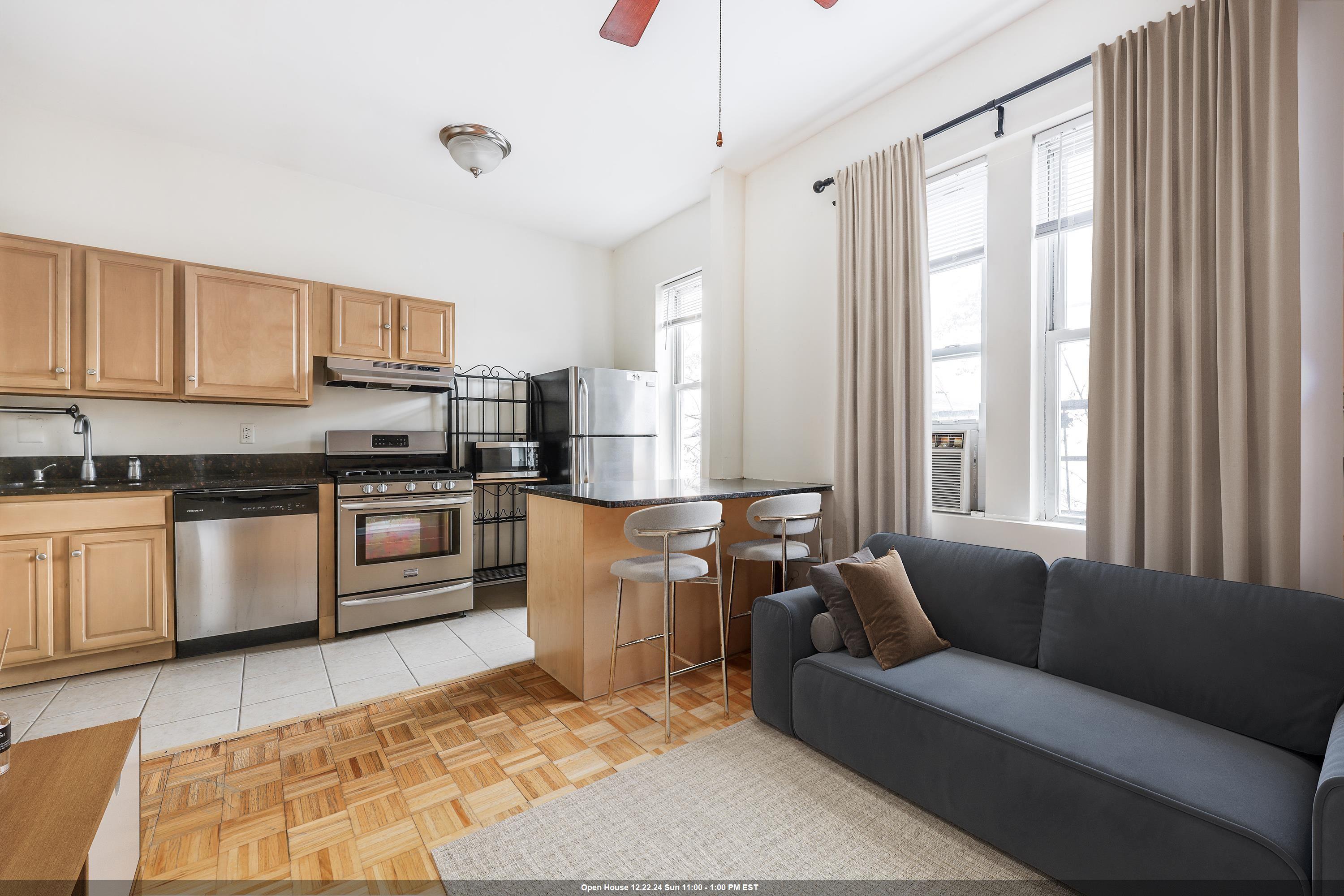 a living room with furniture and kitchen appliances