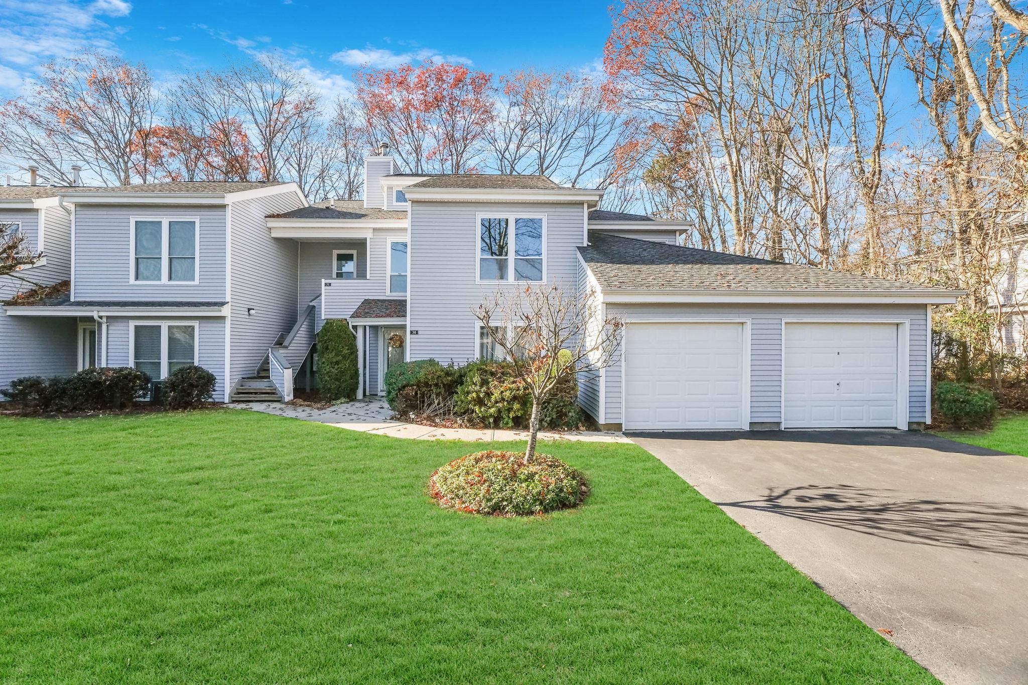 View of front of home featuring a front yard and a garage