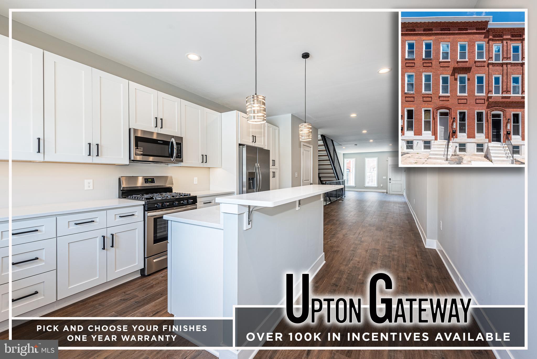 a kitchen with stainless steel appliances granite countertop a stove a sink dishwasher and a microwave oven with white cabinets