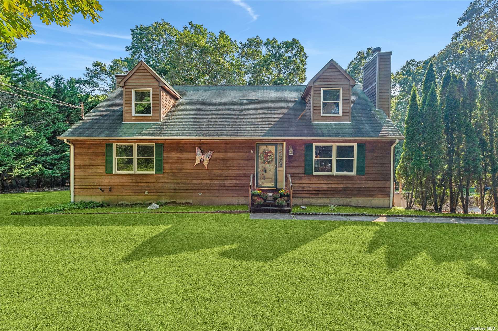 a front view of a house with a garden