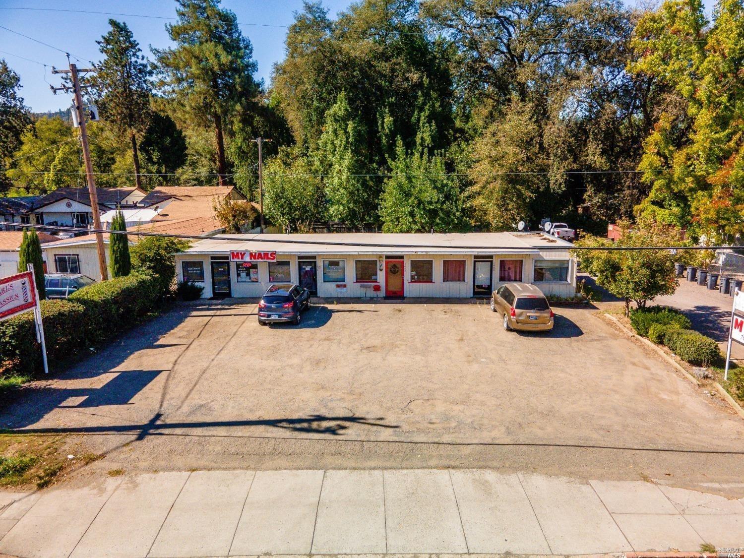 a view of a white house with a yard